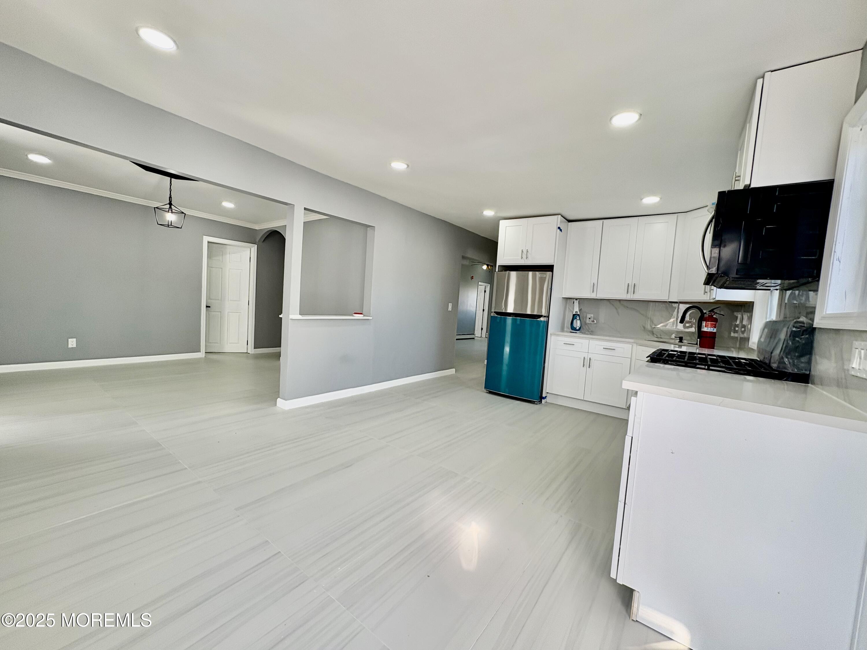 1712 Binnacle Road Forked River, NJ 08731 - Photo 7 of 9 a view of a kitchen with a refrigerator a microwave and a sink