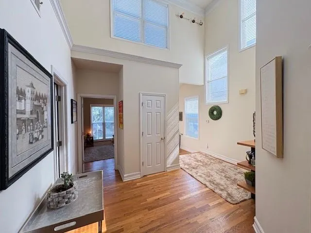 a view of a hallway with wooden floor and furniture
