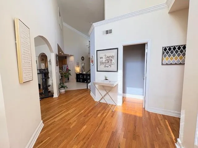 a room with wooden floor and furniture