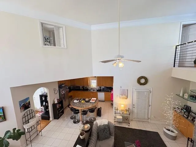 a bedroom with furniture and a fan