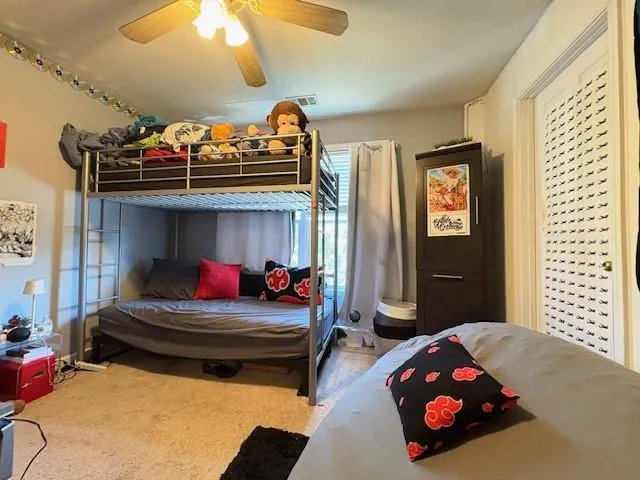 a bedroom with two beds and a chandelier