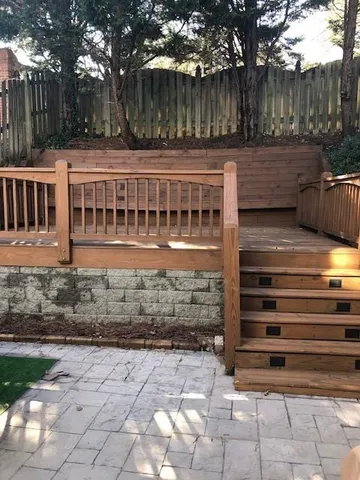 a view of a house with backyard and wooden fence