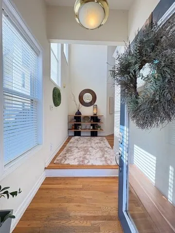 a view of living room with furniture and wooden floor