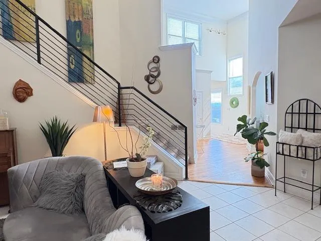 a living room with furniture and a potted plant