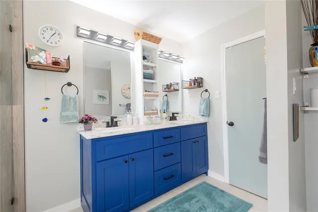 a bathroom with a sink a mirror and a shower