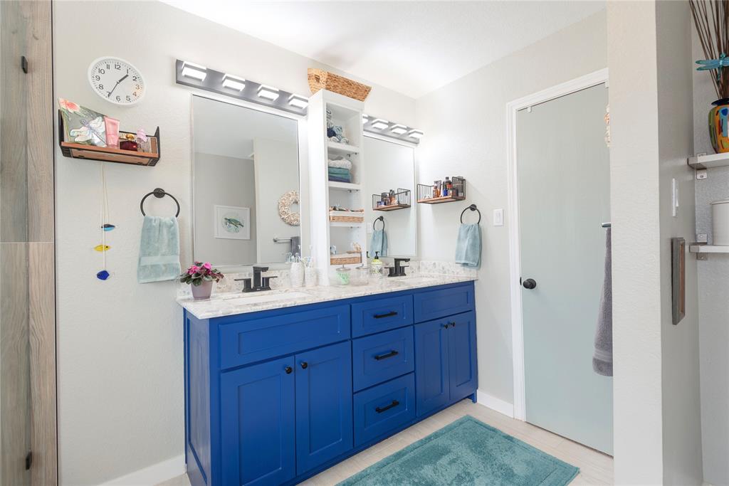 7613 Dockside Drive Rowlett, TX 75088 - Photo 13 of 40 a bathroom with a sink a mirror and a shower