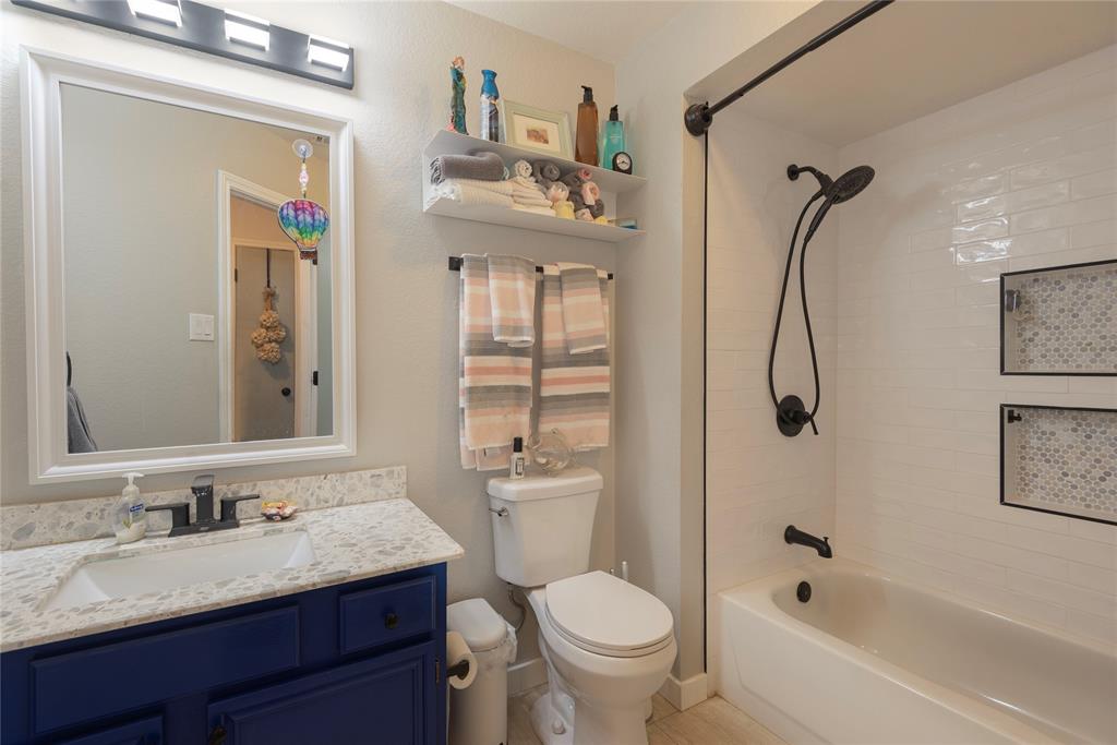 7613 Dockside Drive Rowlett, TX 75088 - Photo 15 of 40 a bathroom with a granite countertop sink toilet and shower