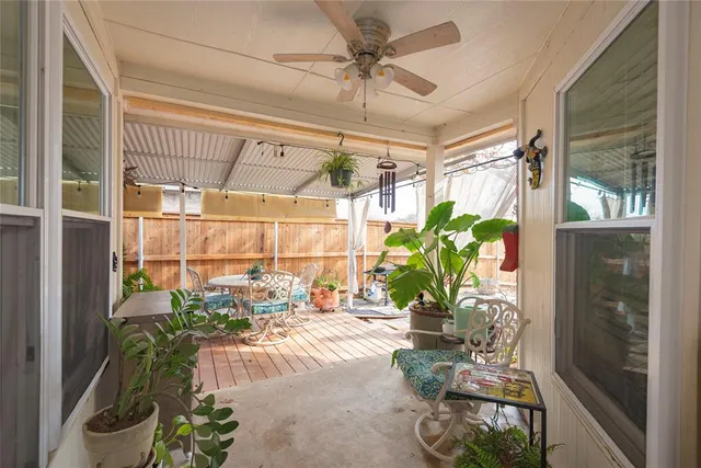 a view of a patio with table and chairs and potted plants