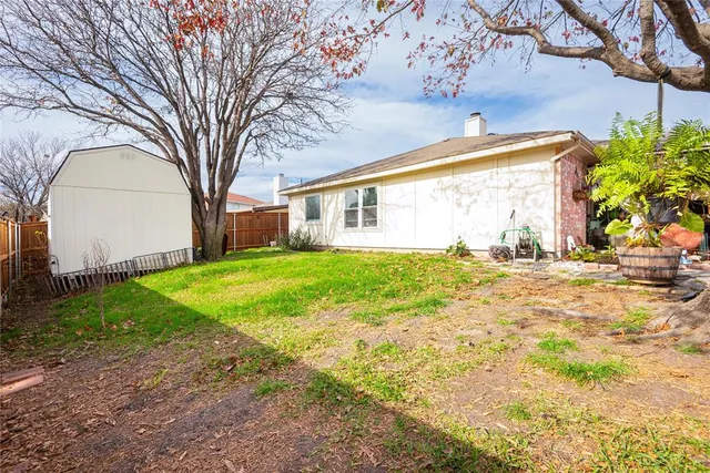 an aerial view of a house with a yard and a garage