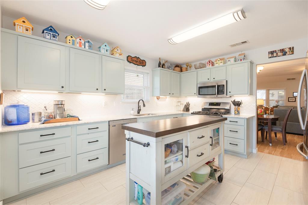 7613 Dockside Drive Rowlett, TX 75088 - Photo 8 of 40 a kitchen with granite countertop a sink and cabinets