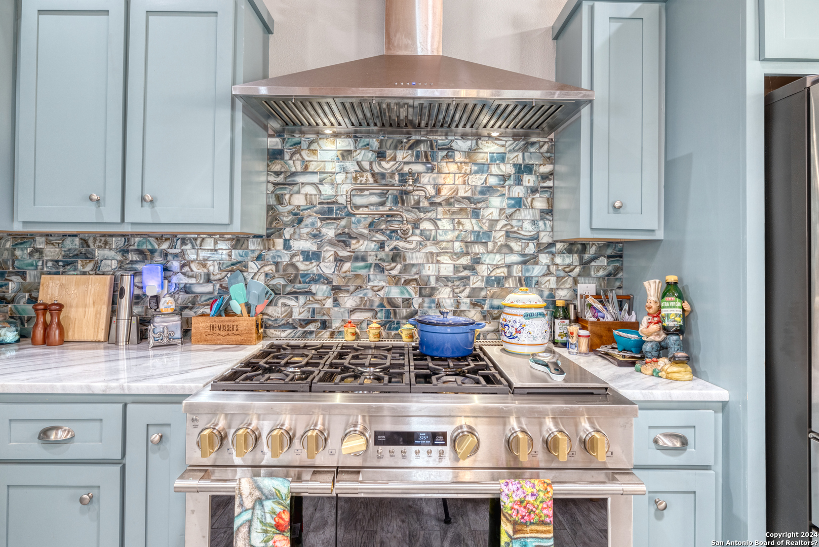93 North Saddle Mountain Road Rio Frio, TX 78879 - Photo 14 of 50 a kitchen with a stove and cabinets