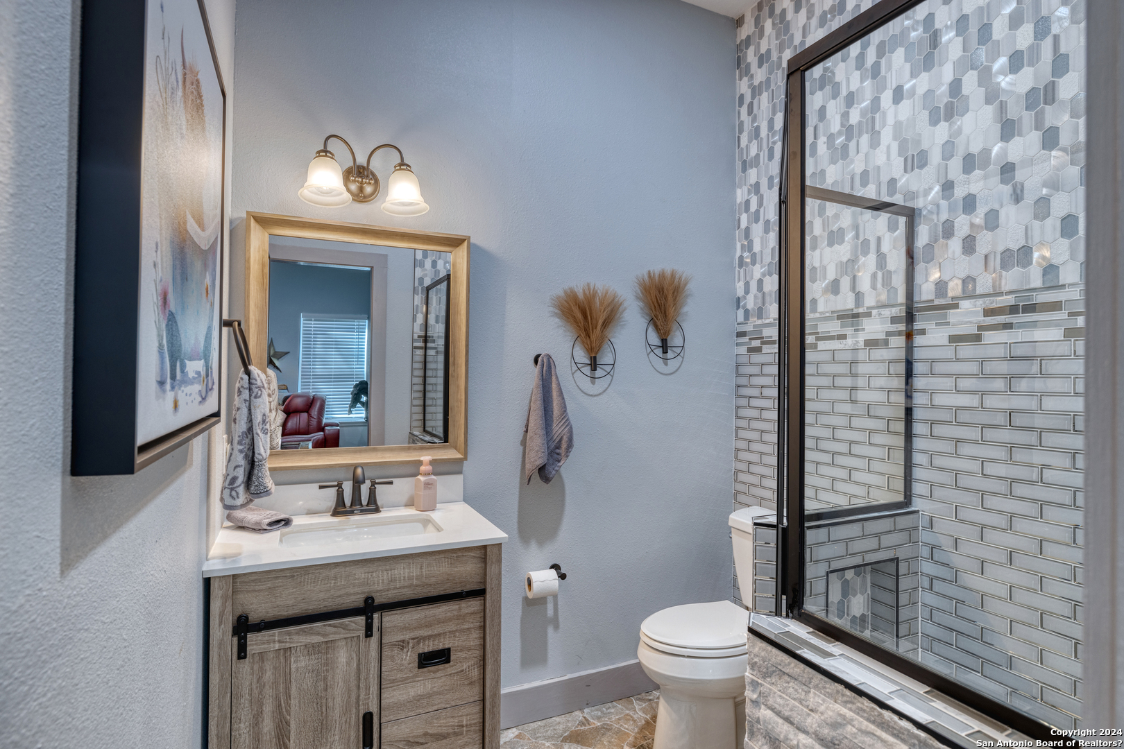 93 North Saddle Mountain Road Rio Frio, TX 78879 - Photo 16 of 50 a bathroom with a sink a toilet and mirror