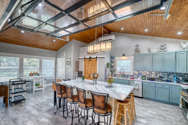 a kitchen with refrigerator and chairs