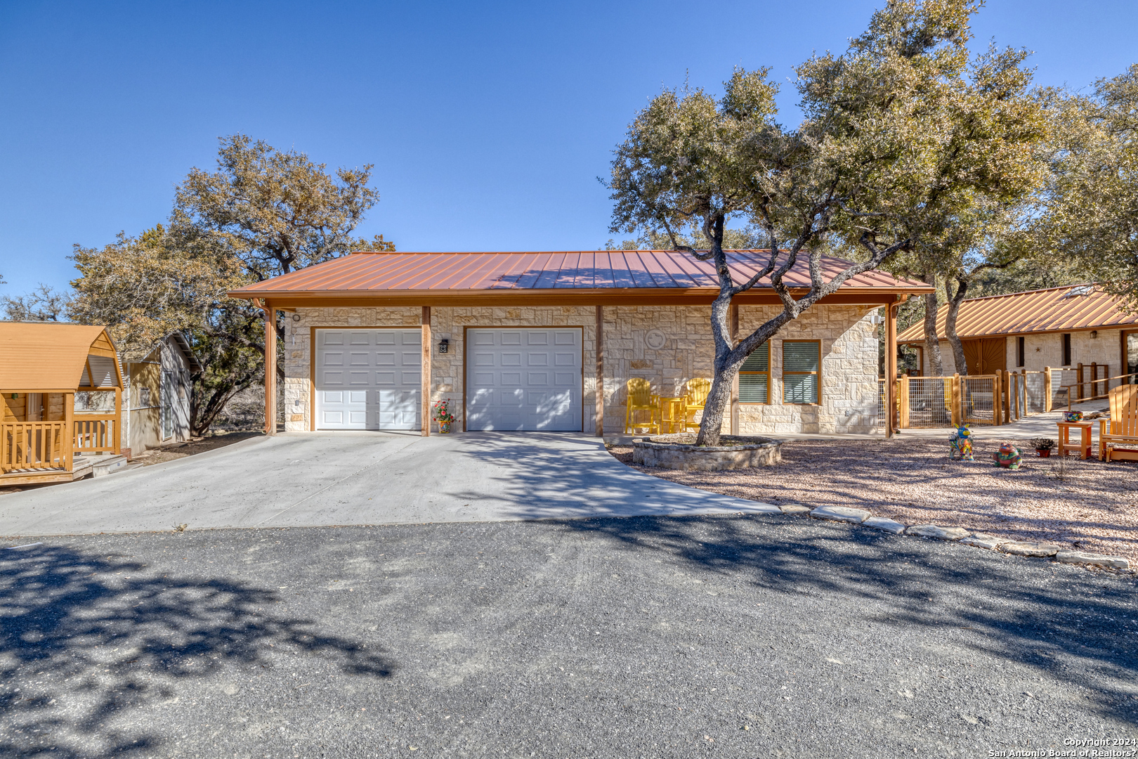 93 North Saddle Mountain Road Rio Frio, TX 78879 - Photo 2 of 50 a front view of a house with a yard and garage