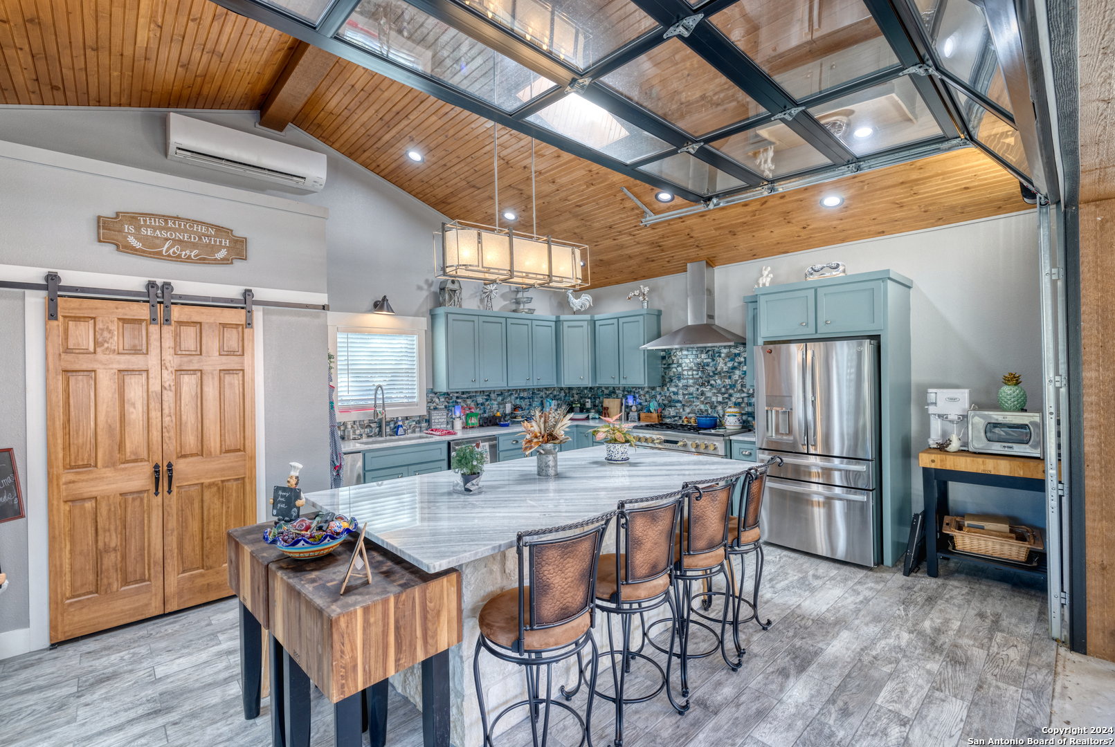 93 North Saddle Mountain Road Rio Frio, TX 78879 - Photo 21 of 50 a kitchen with refrigerator and chairs