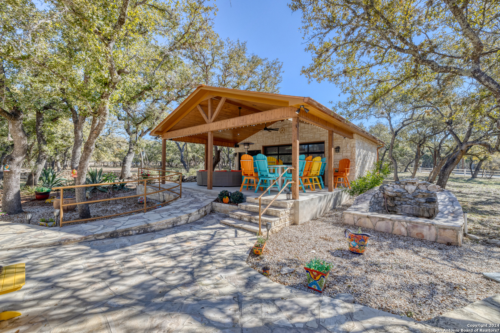 93 North Saddle Mountain Road Rio Frio, TX 78879 - Photo 24 of 50 a view of a patio with table and chairs under an umbrella