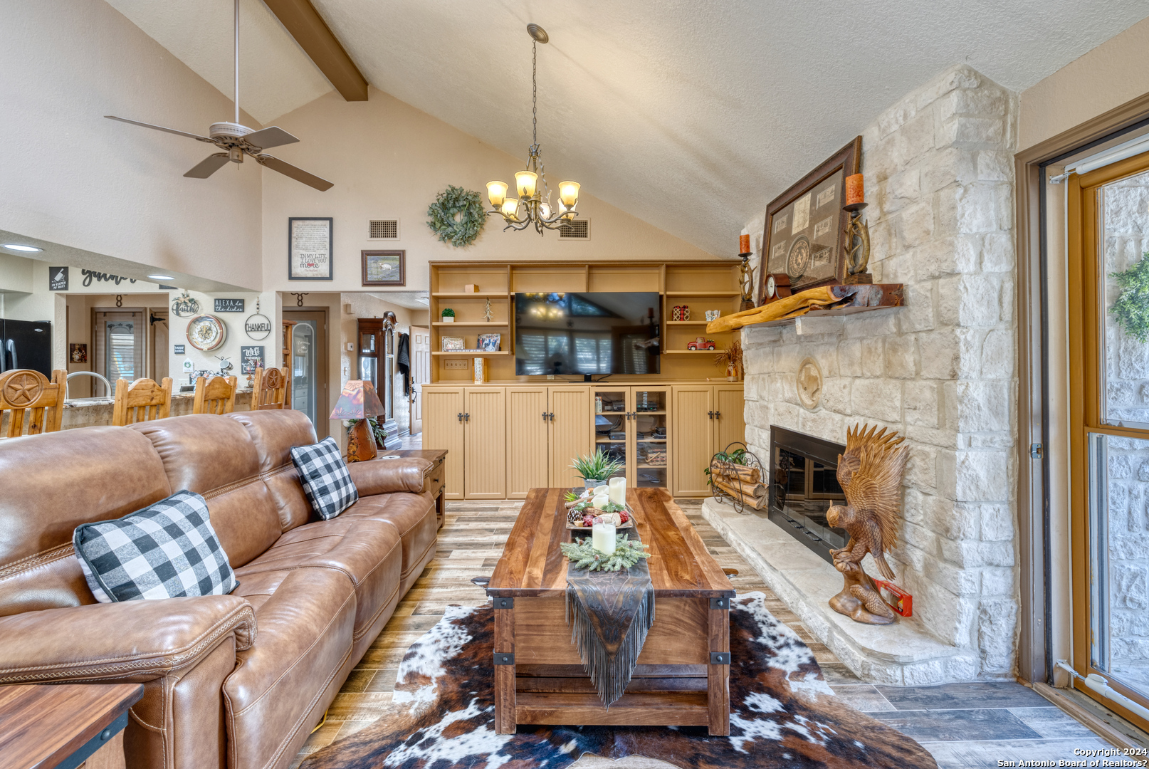 93 North Saddle Mountain Road Rio Frio, TX 78879 - Photo 25 of 50 a living room with furniture a fireplace and a chandelier