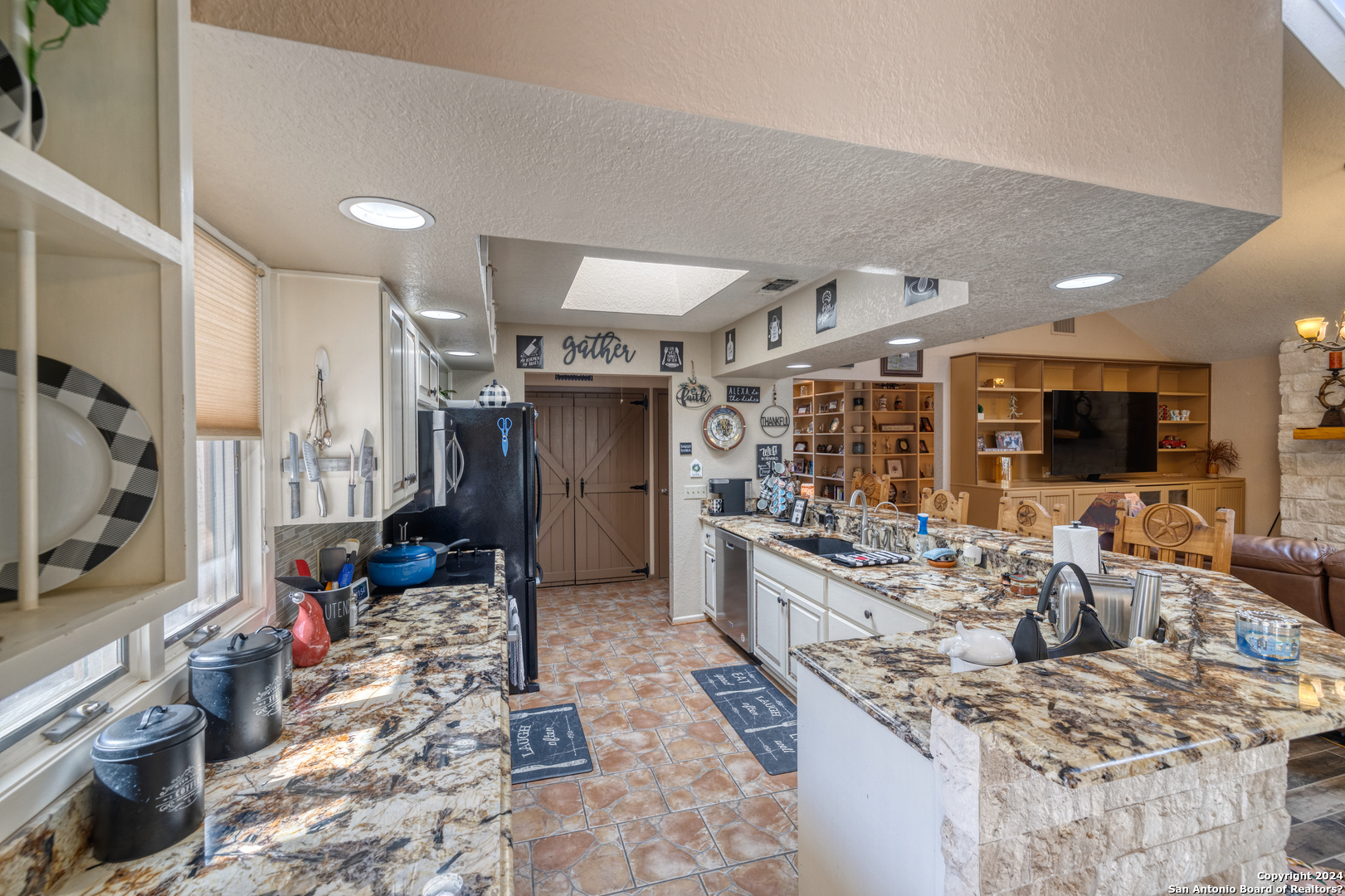 93 North Saddle Mountain Road Rio Frio, TX 78879 - Photo 29 of 50 a kitchen with stainless steel appliances kitchen island granite countertop a stove and a sink