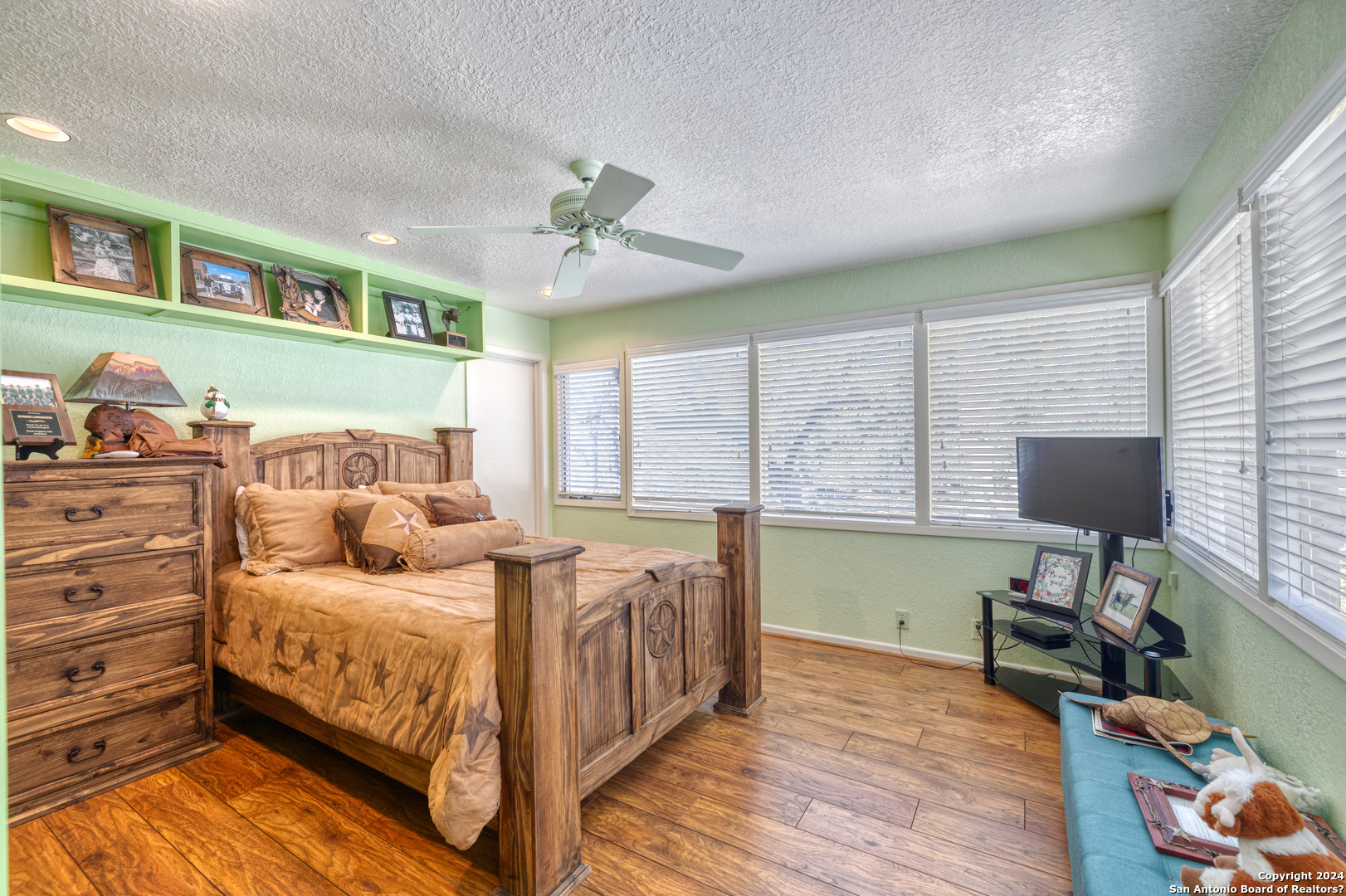 93 North Saddle Mountain Road Rio Frio, TX 78879 - Photo 38 of 50 a bedroom with a bed and a chandelier