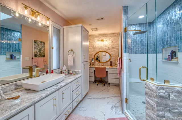 a bathroom with a sink a toilet and a shower