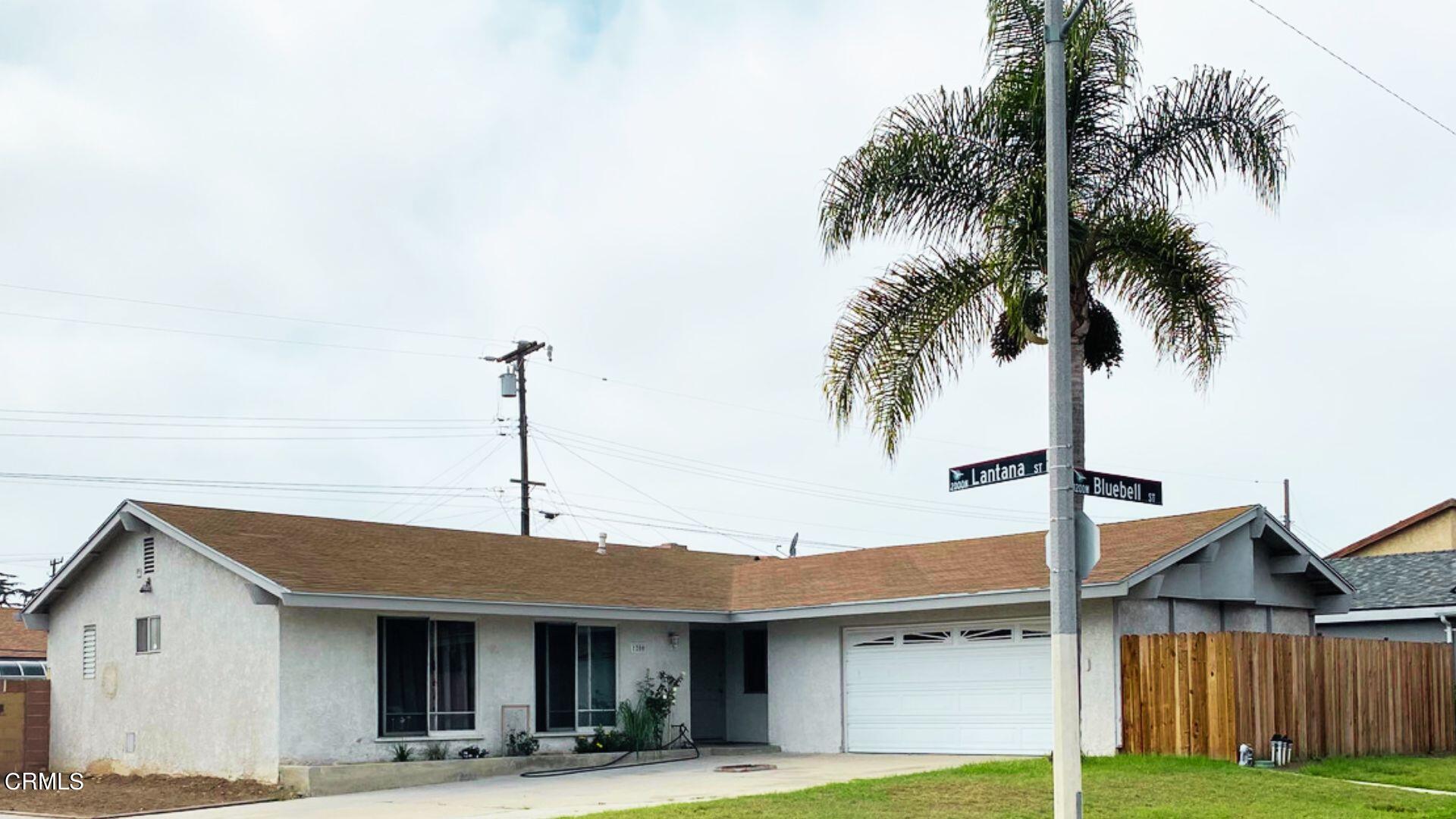 1200 Bluebell Street Oxnard, CA 93036 - Photo 1 of 6 a front view of house with yard and palm tree