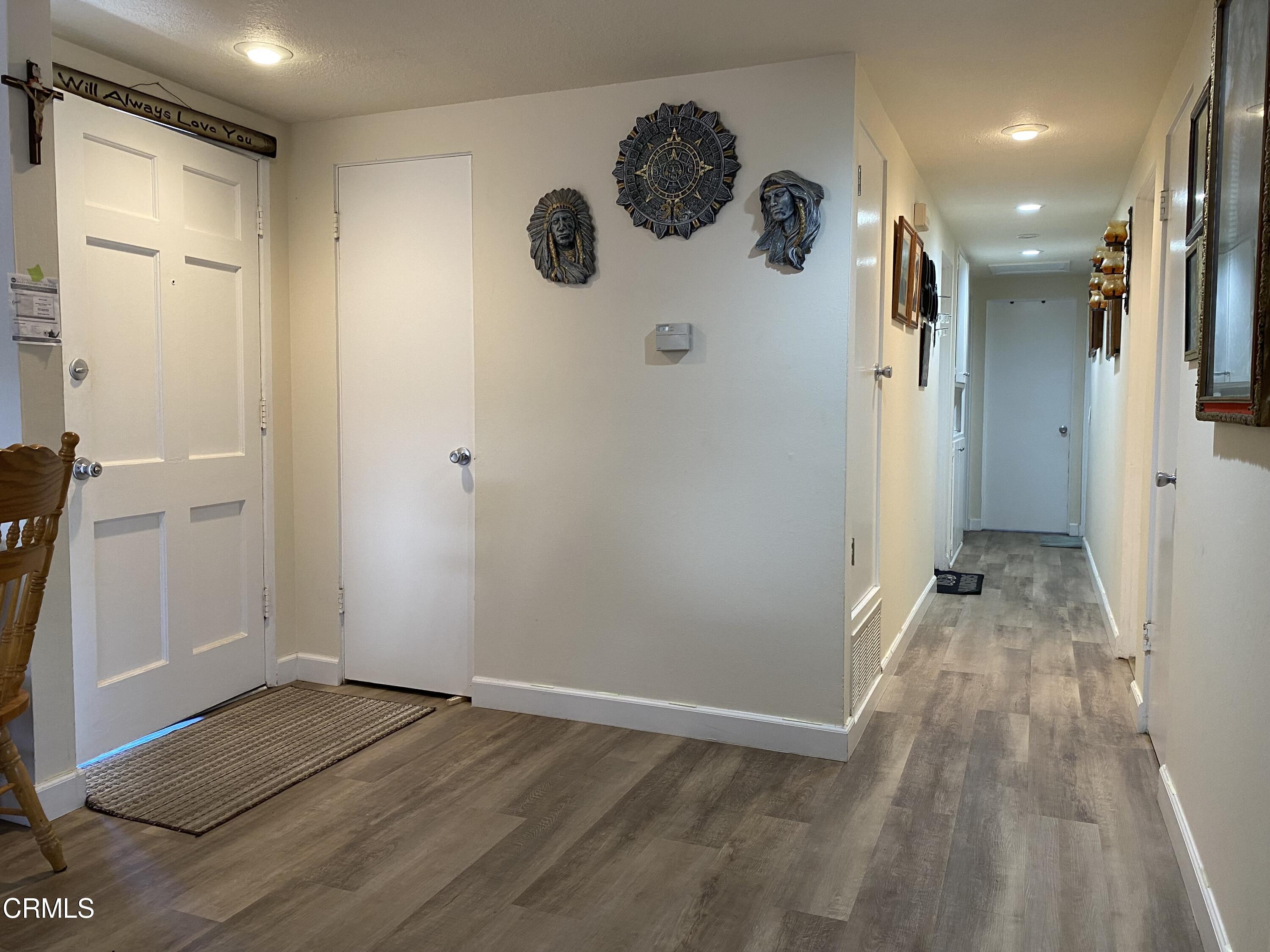 1200 Bluebell Street Oxnard, CA 93036 - Photo 2 of 6 a view of a hallway with wooden floor and a cabinet