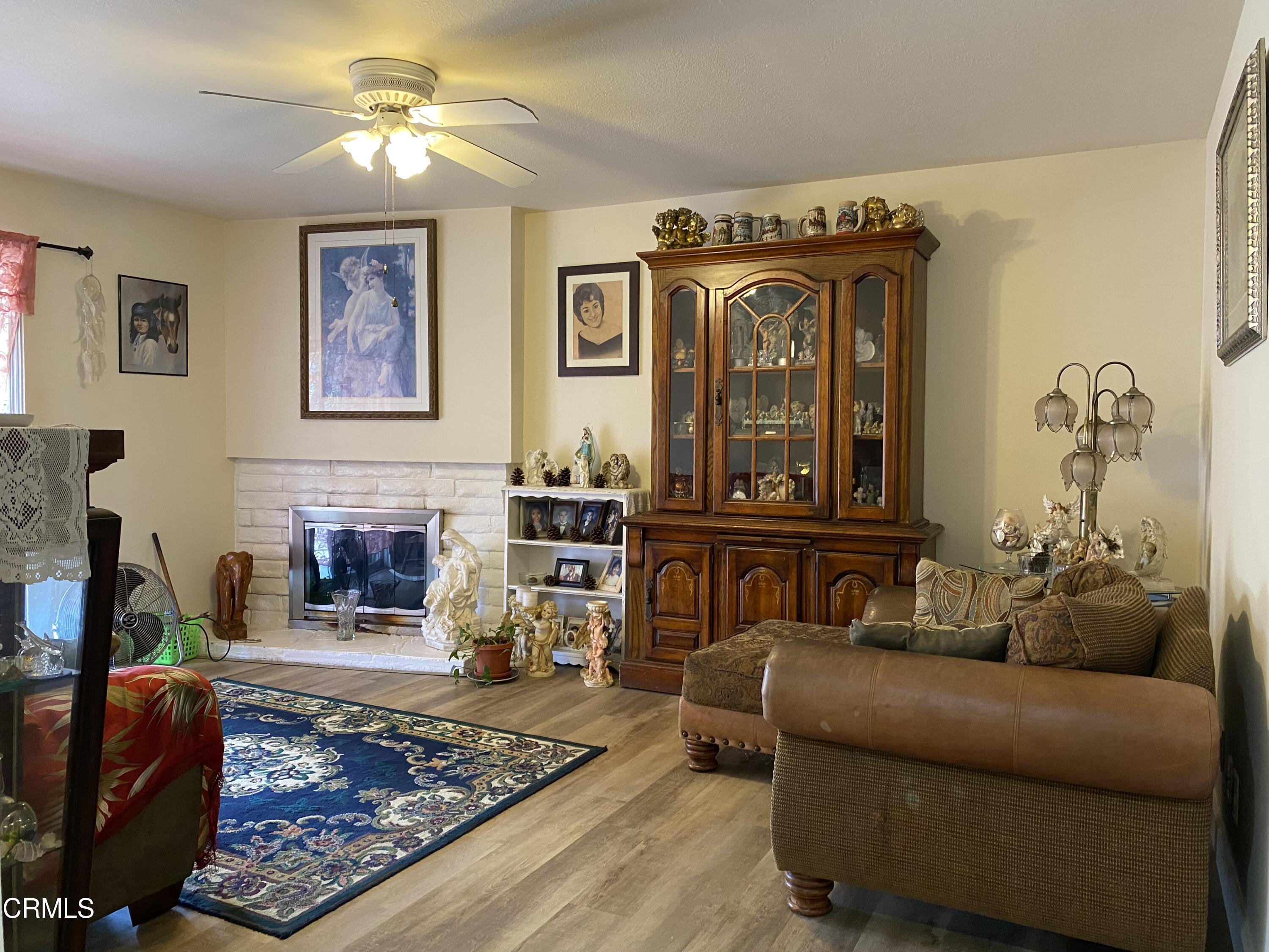 1200 Bluebell Street Oxnard, CA 93036 - Photo 3 of 6 a living room with furniture and a fireplace