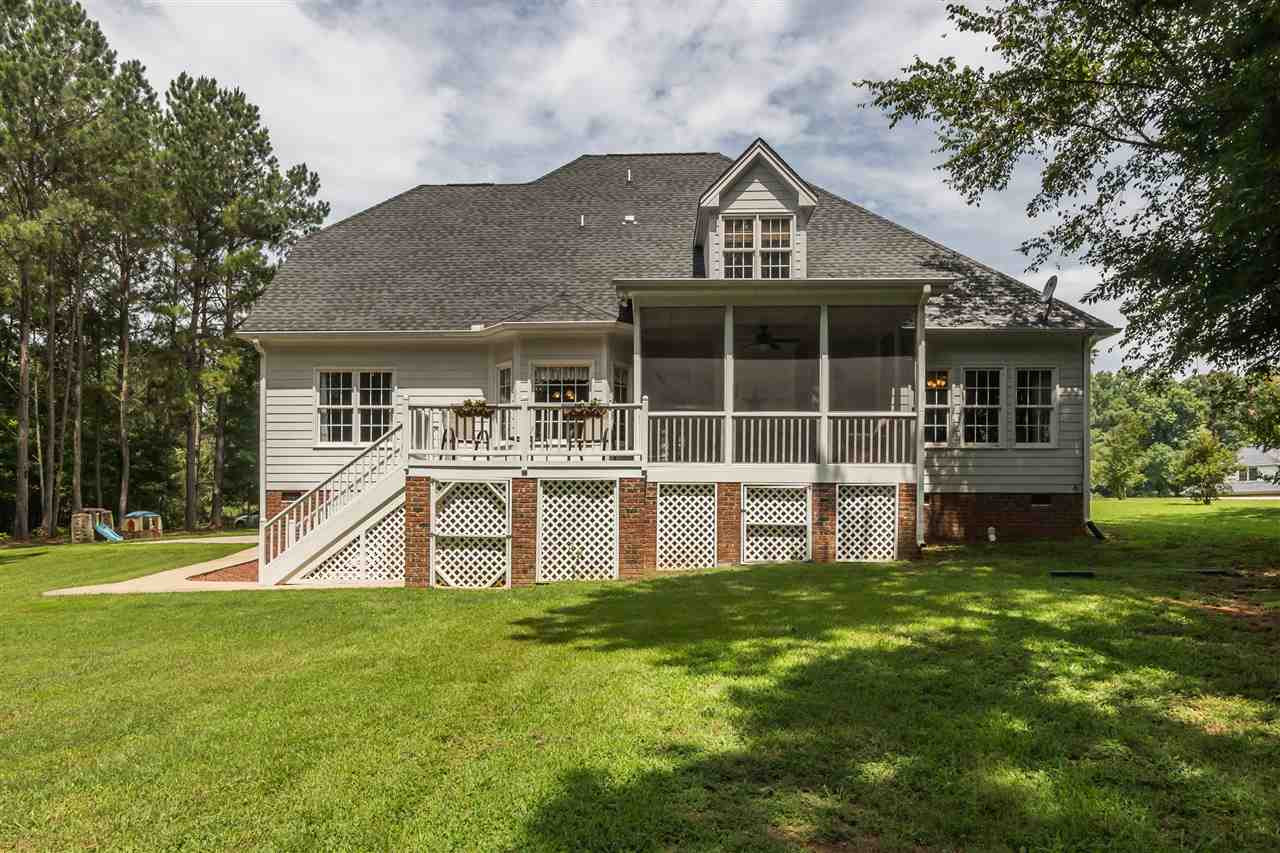 1132 Rhea Drive Garner, NC 27529 - Photo 22 of 25 The .7 acre lot has something for everyone - ample lawn space to play, plus plenty of mature trees for privacy and shade. And it's located next to community-owned land! An oversized crawl space provides storage for out-of-season outdoor items. Backyard and Rear View