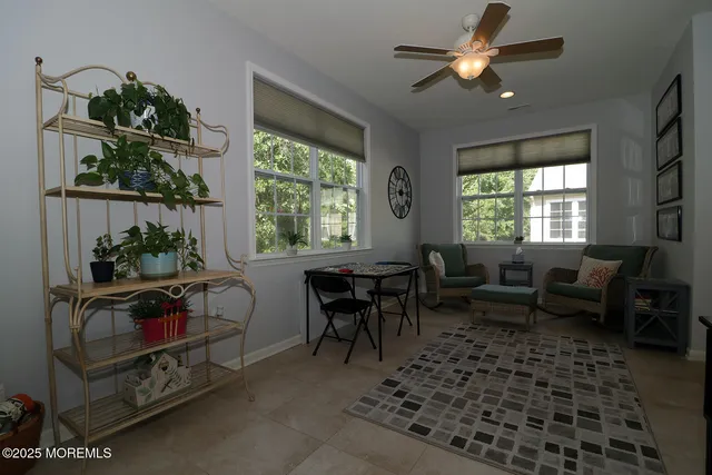 a living room with furniture a chandelier and a window
