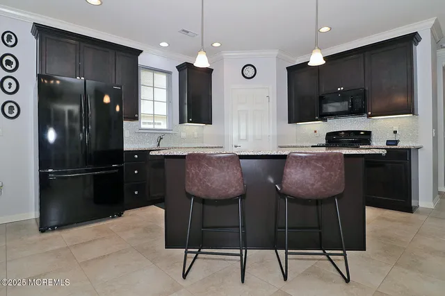 a kitchen with stainless steel appliances a stove microwave and refrigerator