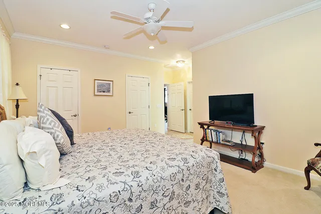 a bedroom with a bed furniture and a flat screen tv