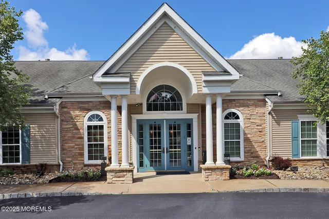 a living room with furniture a bookshelf and a book shelf