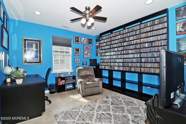 a living room with furniture a flat screen tv and a window