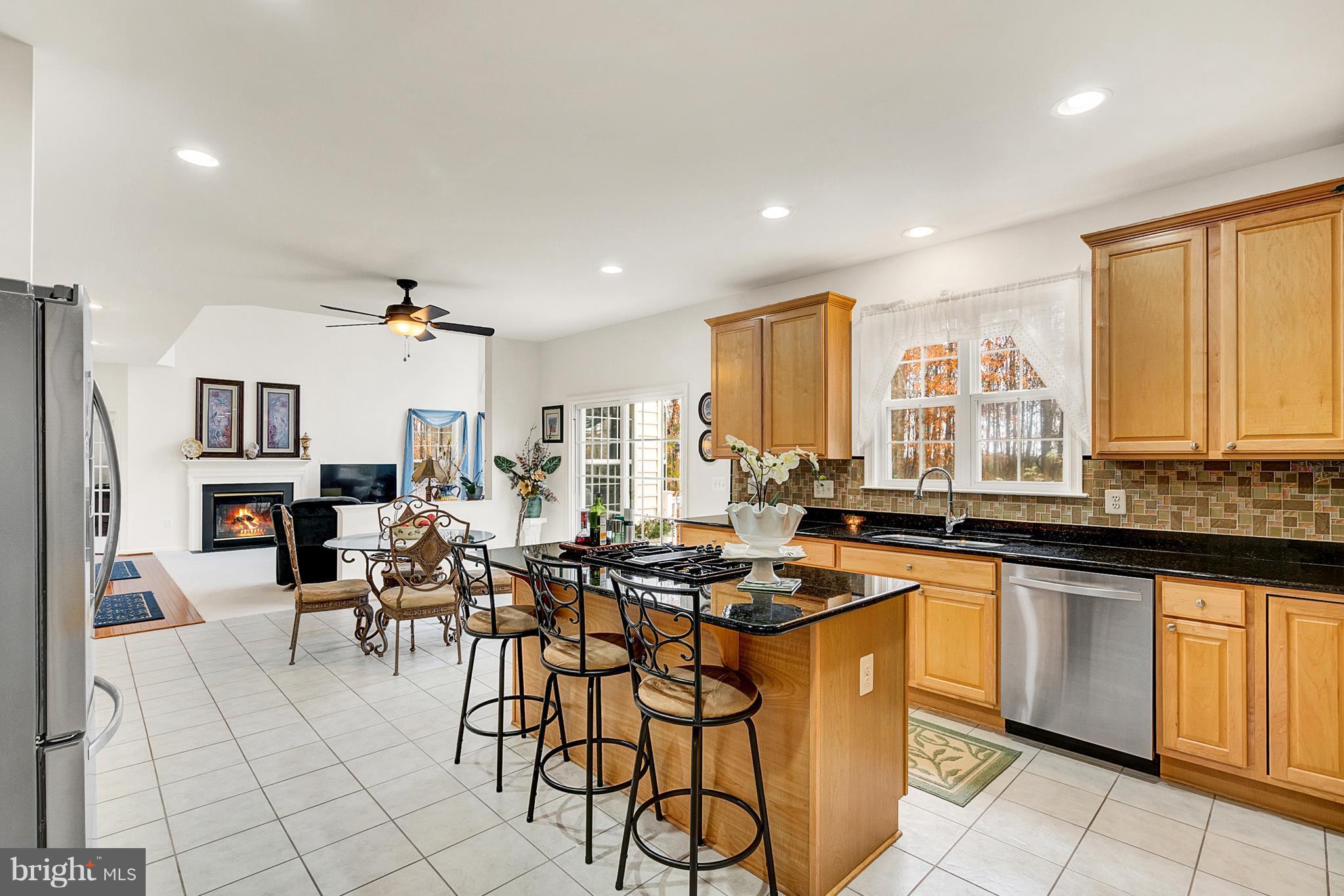 842 Kingsbrook Road Culpeper, VA 22701 - Photo 11 of 30 a kitchen with stainless steel appliances granite countertop a stove a sink dishwasher and a refrigerator with wooden floor