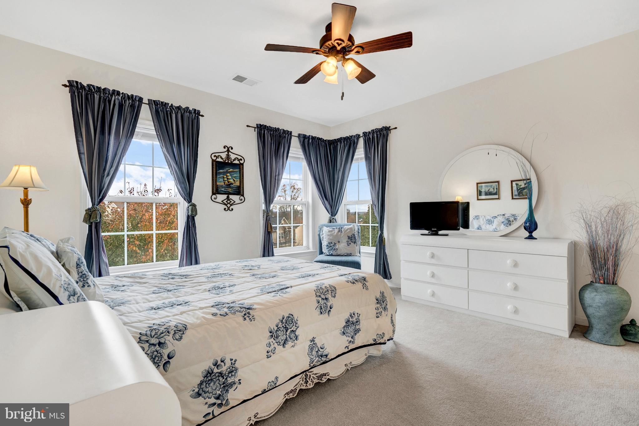 842 Kingsbrook Road Culpeper, VA 22701 - Photo 14 of 30 a bedroom with a large bed a flat tv screen and a dresser