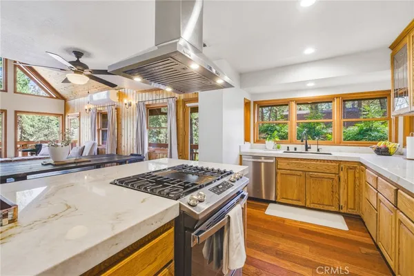 a kitchen with stainless steel appliances granite countertop a sink and cabinets