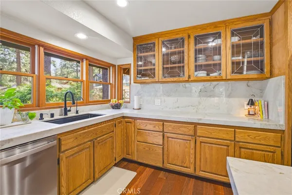 a kitchen with stainless steel appliances granite countertop a sink and a stove