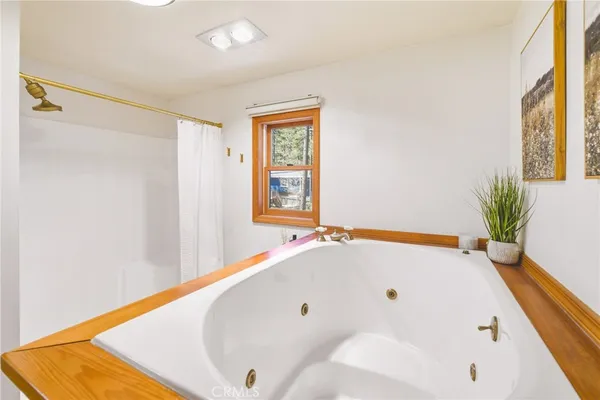 a spacious bedroom with a bed and wooden floors