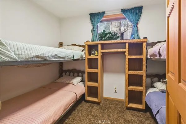 a balcony with wooden floor and outdoor seating