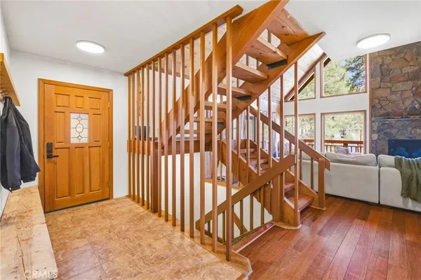 a view of an entryway with wooden floor and door
