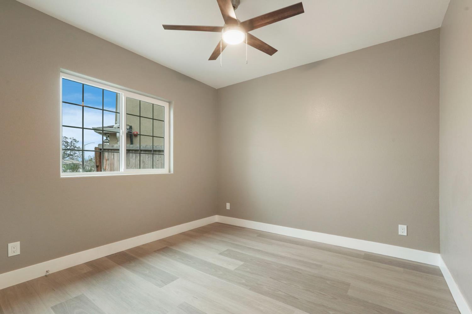 9421 Carter Court Stockton, CA 95209 - Photo 11 of 31 wooden floor in an empty room with a window