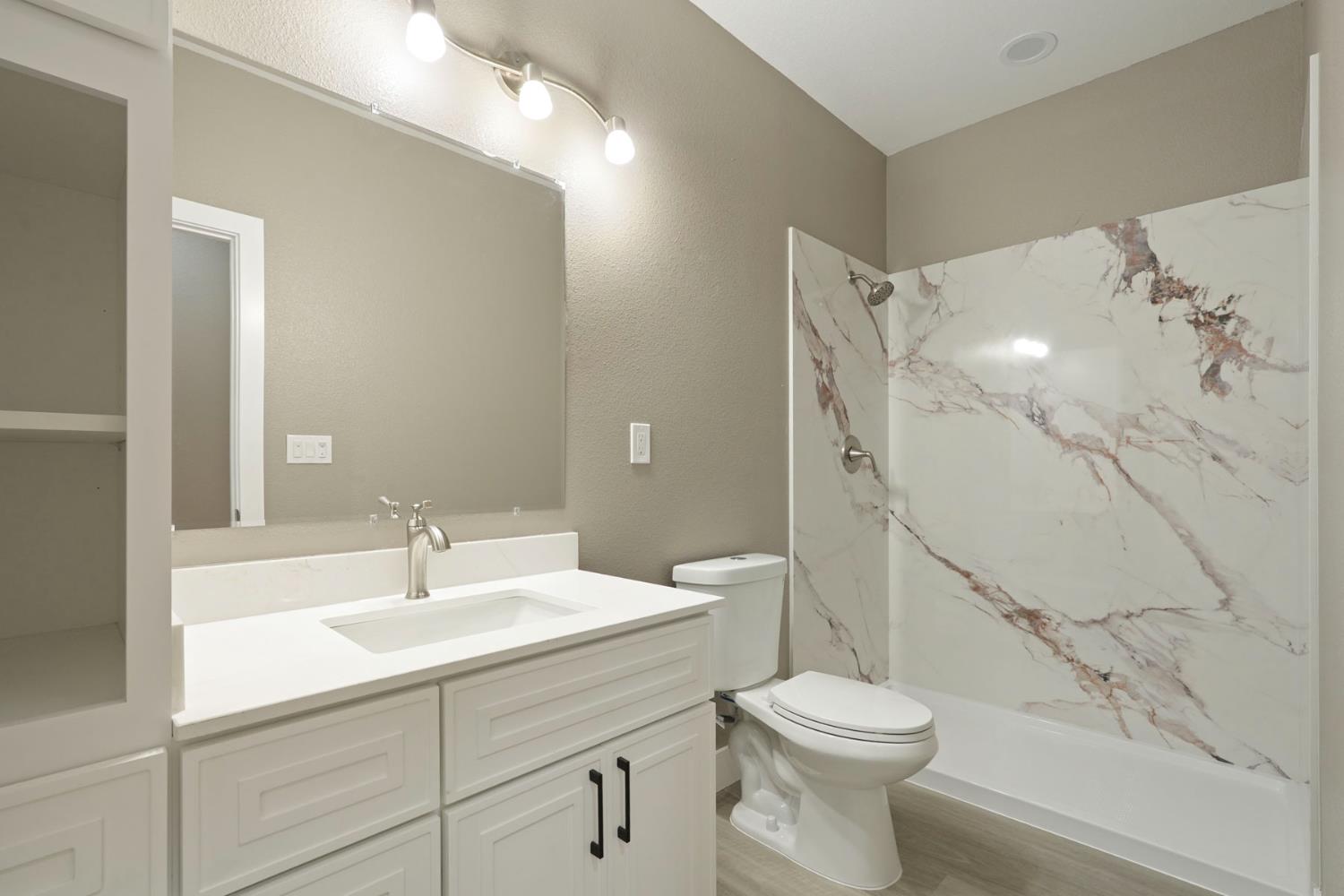 9421 Carter Court Stockton, CA 95209 - Photo 13 of 31 a bathroom with a sink toilet and shower