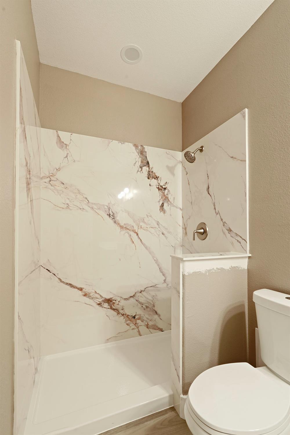 9421 Carter Court Stockton, CA 95209 - Photo 24 of 31 a white toilet sitting next to a bathroom sink