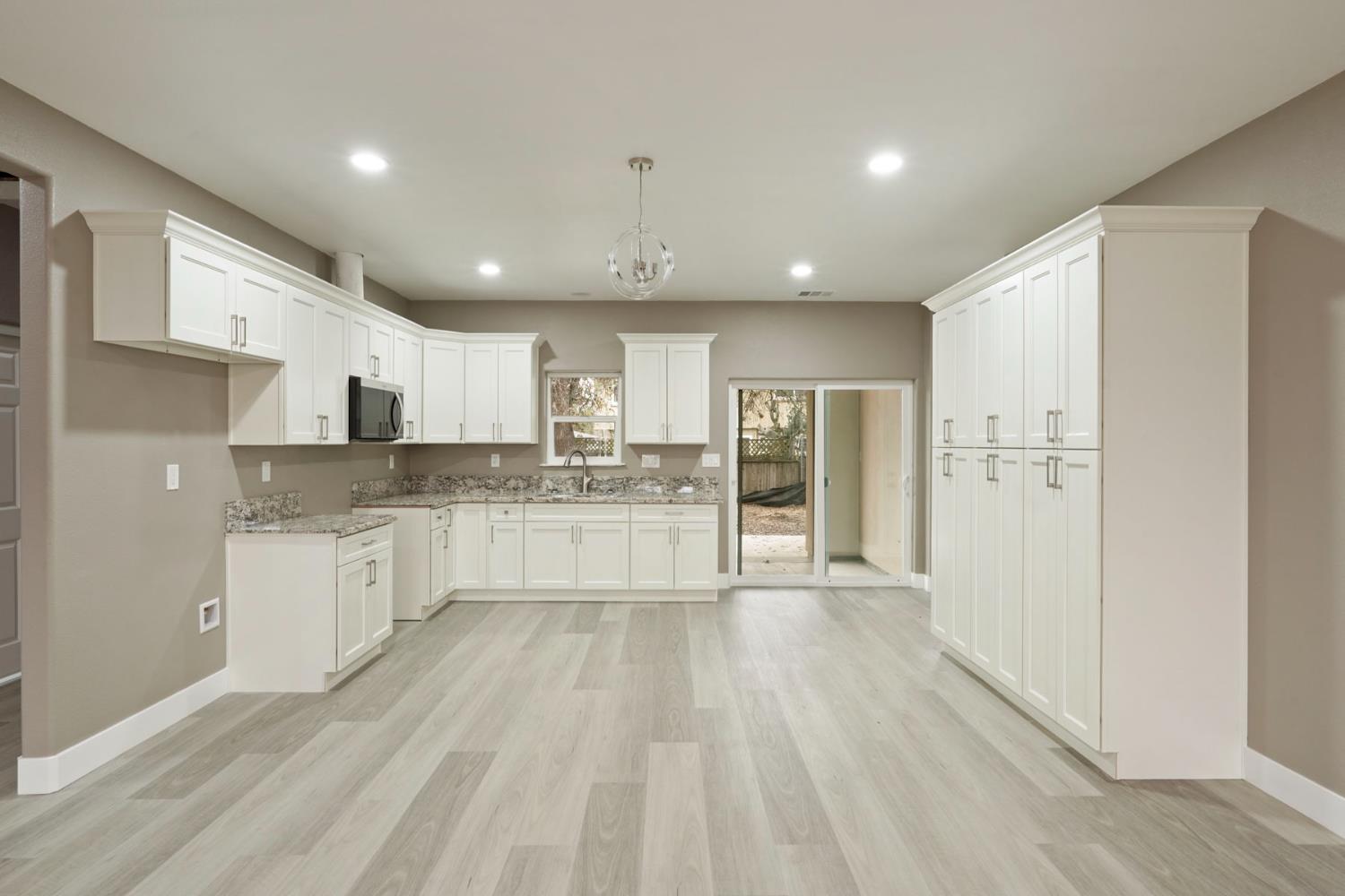 9421 Carter Court Stockton, CA 95209 - Photo 5 of 31 a large kitchen with kitchen island a sink stainless steel appliances and cabinets