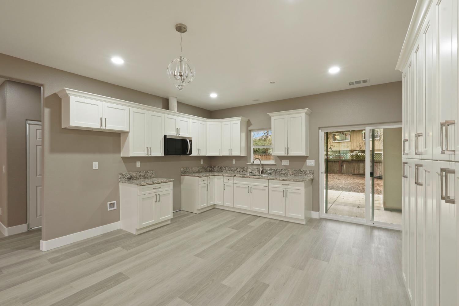 9421 Carter Court Stockton, CA 95209 - Photo 6 of 31 a large kitchen with kitchen island a sink stainless steel appliances and cabinets