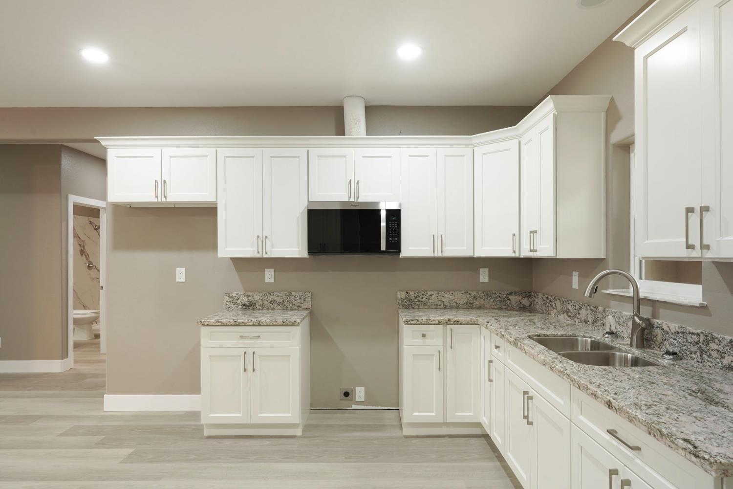 9421 Carter Court Stockton, CA 95209 - Photo 7 of 31 a kitchen with stainless steel appliances granite countertop a sink a stove and a refrigerator