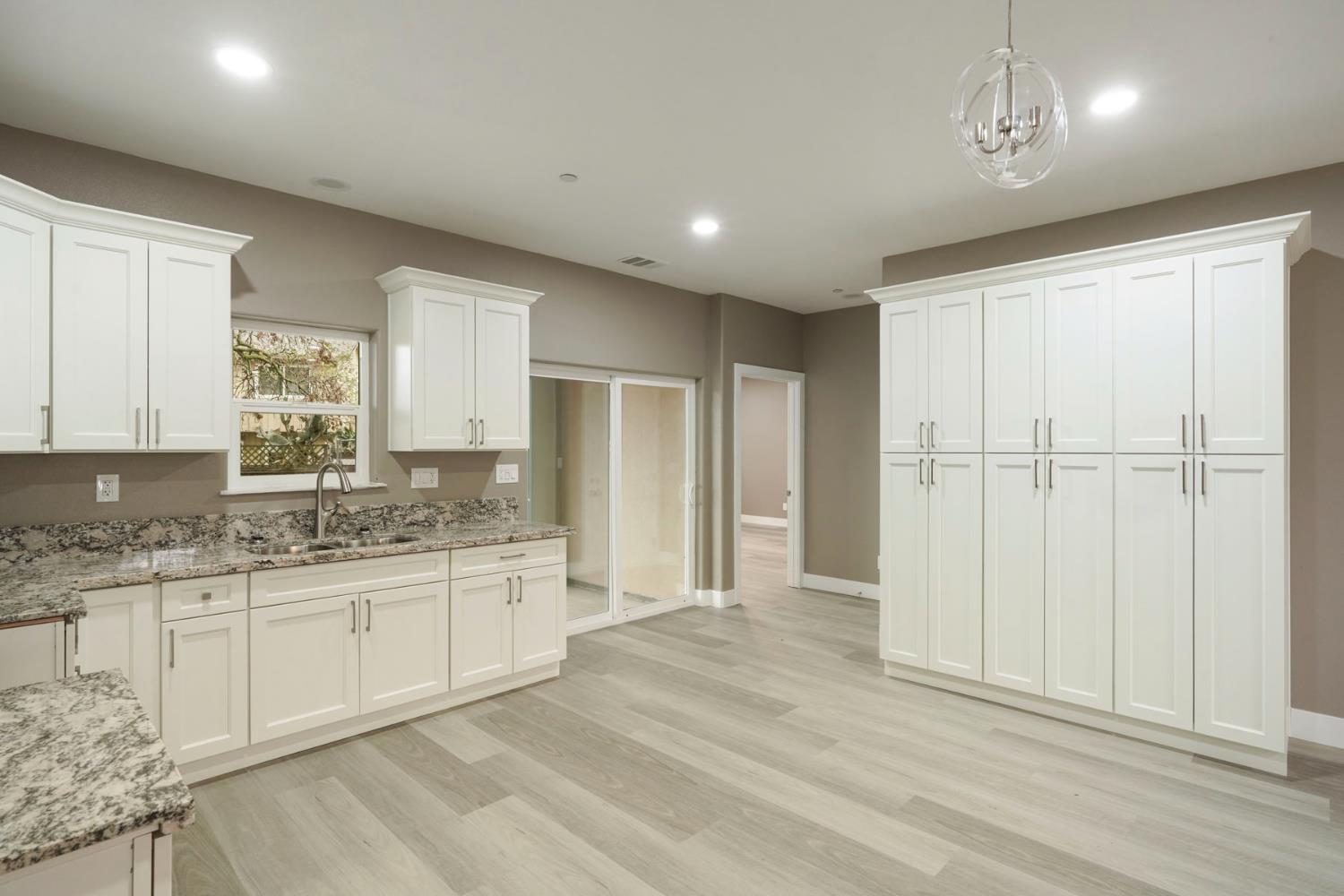 9421 Carter Court Stockton, CA 95209 - Photo 8 of 31 a bathroom with a granite countertop sink and a mirror