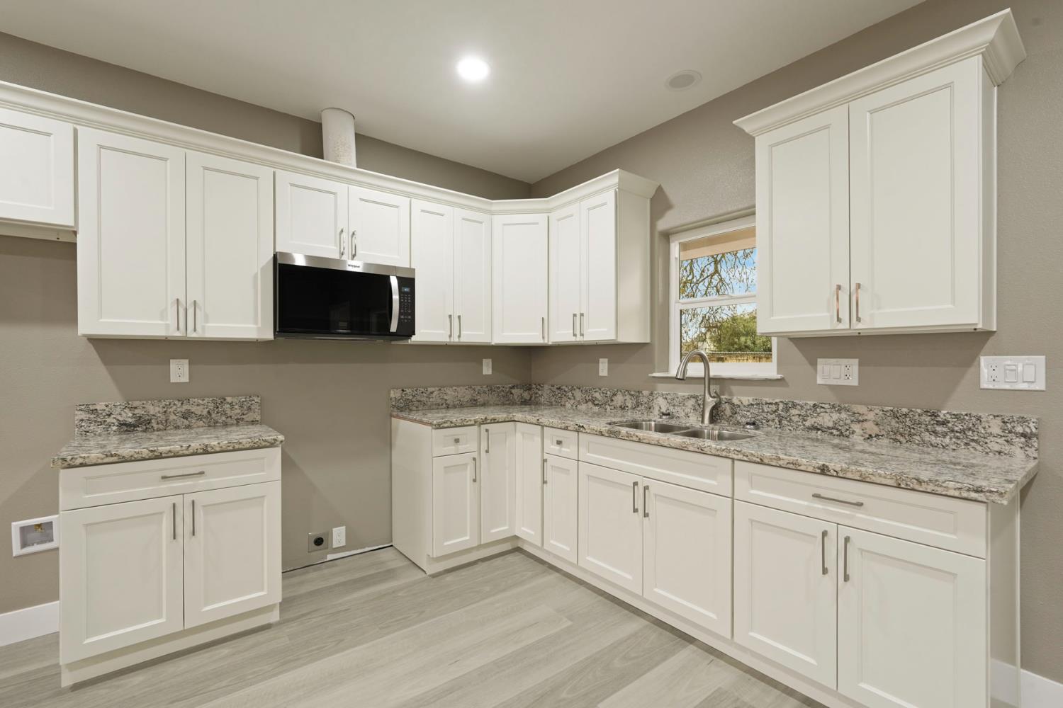 9421 Carter Court Stockton, CA 95209 - Photo 10 of 31 a kitchen with stainless steel appliances granite countertop a sink and a stove top oven