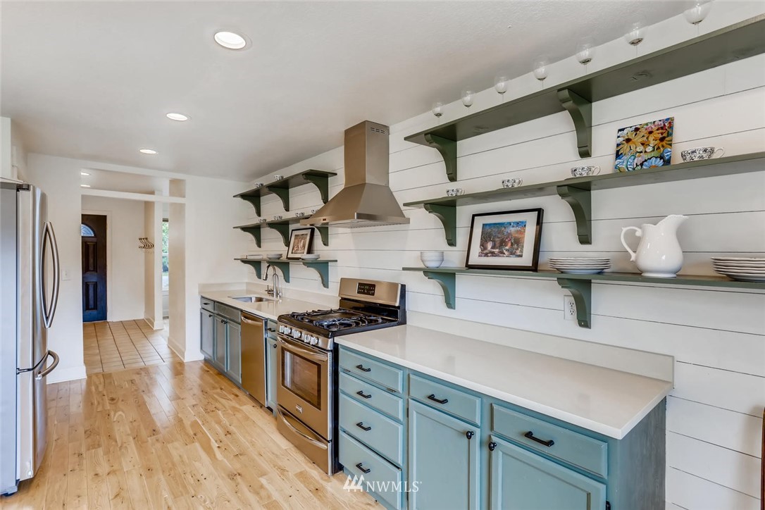 216 174th Street Southwest Bothell, WA 98012 - Photo 11 of 27 a kitchen with stainless steel appliances granite countertop a stove and a refrigerator