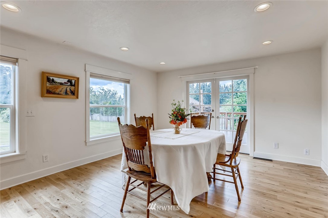 216 174th Street Southwest Bothell, WA 98012 - Photo 13 of 27 a view of a dining room with furniture window and wooden floor